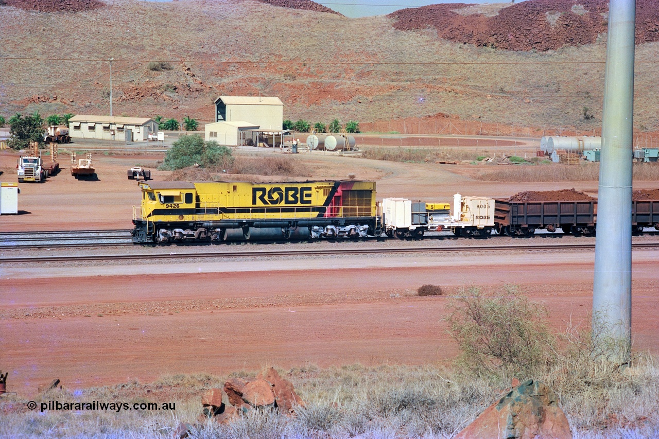 247-04
Cape Lambert, Robe River's 9426 a Comeng WA rebuild from ALCo Schenectady NY model C636 serial 3499-3 originally built in January 1968 for Pennsylvania as #6332, Penn Central 6332 and finally Conrail 6782. Purchased in 1986 and rebuilt by Comeng WA into C636R before delivery to Robe in November 1986. This loco also went on to become DR 8401 for construction of FMG's railway in 2007-08. Seen here in the South Yard waiting to drag a loaded rake down to the car dumper. Approximate location of train is [url=https://goo.gl/maps/tRtaJxMULpjBhtqa8]here[/url]. 22nd May 2002.
Keywords: 9426;Comeng-WA;C636R;WA143-1;rebuild;ALCo;Schenectady-NY;C636;Conrail;6782;3499-3;