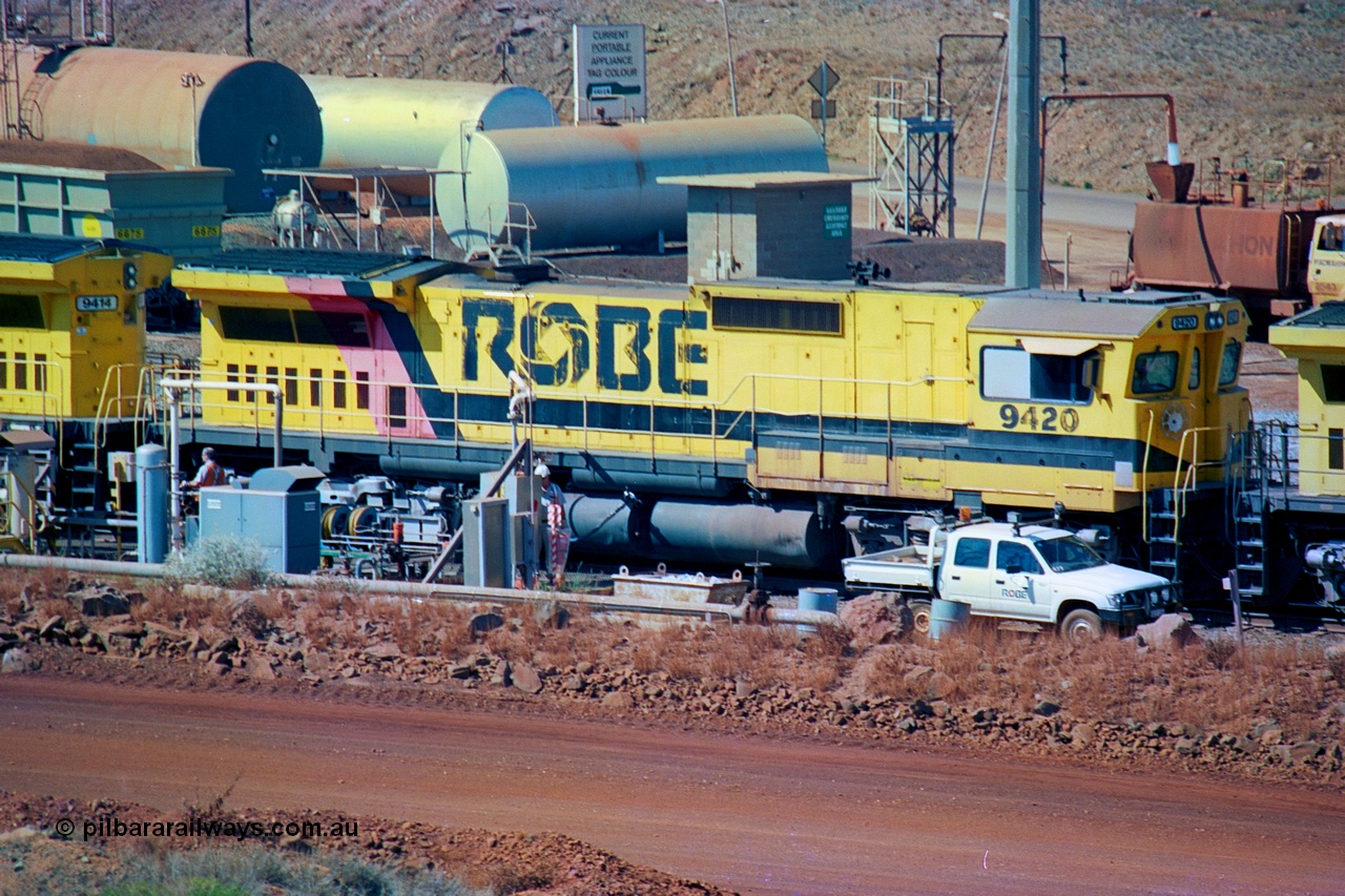 247-09
Cape Lambert fuel point, Robe River locomotive 9420 which is a Goninan WA ALCo to GE rebuild CM40-8M with serial 8109-03 / 91-119 from March 1991 riding on Hi-Ad bogies and was originally an ALCo Schenectady built C630 serial 3486-4 and built new for Chesapeake & Ohio (USA) as their 2103. It is one of four C630 ALCo units purchased in 1974 and delivered to Robe in January 1975. Everything below the frame is ALCo while above is GE and Pilbara Cab. Approximate location of the locos is [url=https://goo.gl/maps/DEynwwkV9PZra5Gm7]here[/url]. 22nd May 2002.
Keywords: 9420;Goninan;GE;CM40-8M;8109-03/91-119;rebuild;ALCo;C630;3486-4;C+O;2103;