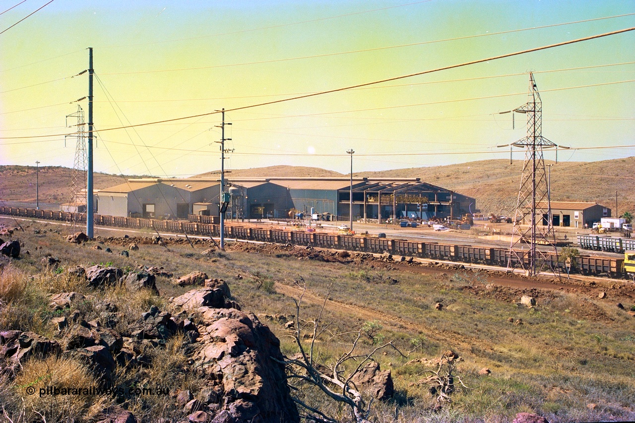 247-14
Cape Lambert overview of the railway workshops buildings and service shops for surface mining equipment. Approximate location of photo is [url=https://goo.gl/maps/B9F4estGGPbd2GrB6]here[/url]. 22nd May 2002.
