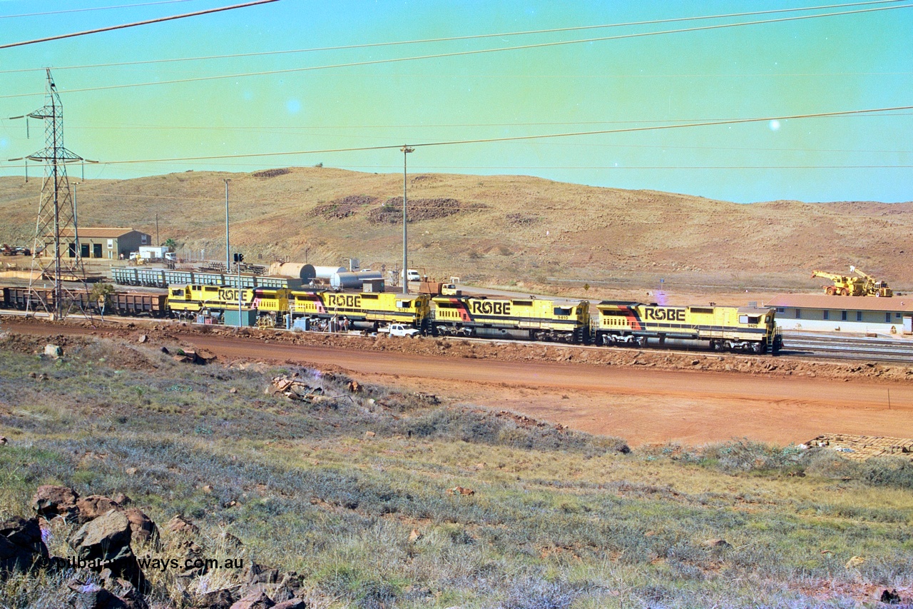 247-15
Cape Lambert overview of the fuel point, with a brace of four CM40-8M rebuilds finishing up refuelling before departing with another empty train. The workshops are to the left of the picture. Where I'm standing to take the picture is now all stockpile. Approximate location of photo is [url=https://goo.gl/maps/B9F4estGGPbd2GrB6]here[/url]. 22nd May 2002.
Keywords: 9425;Goninan;GE;CM40-8M;6266-8/89-85;rebuild;AE-Goodwin;ALCo;M636;G-6041-4;