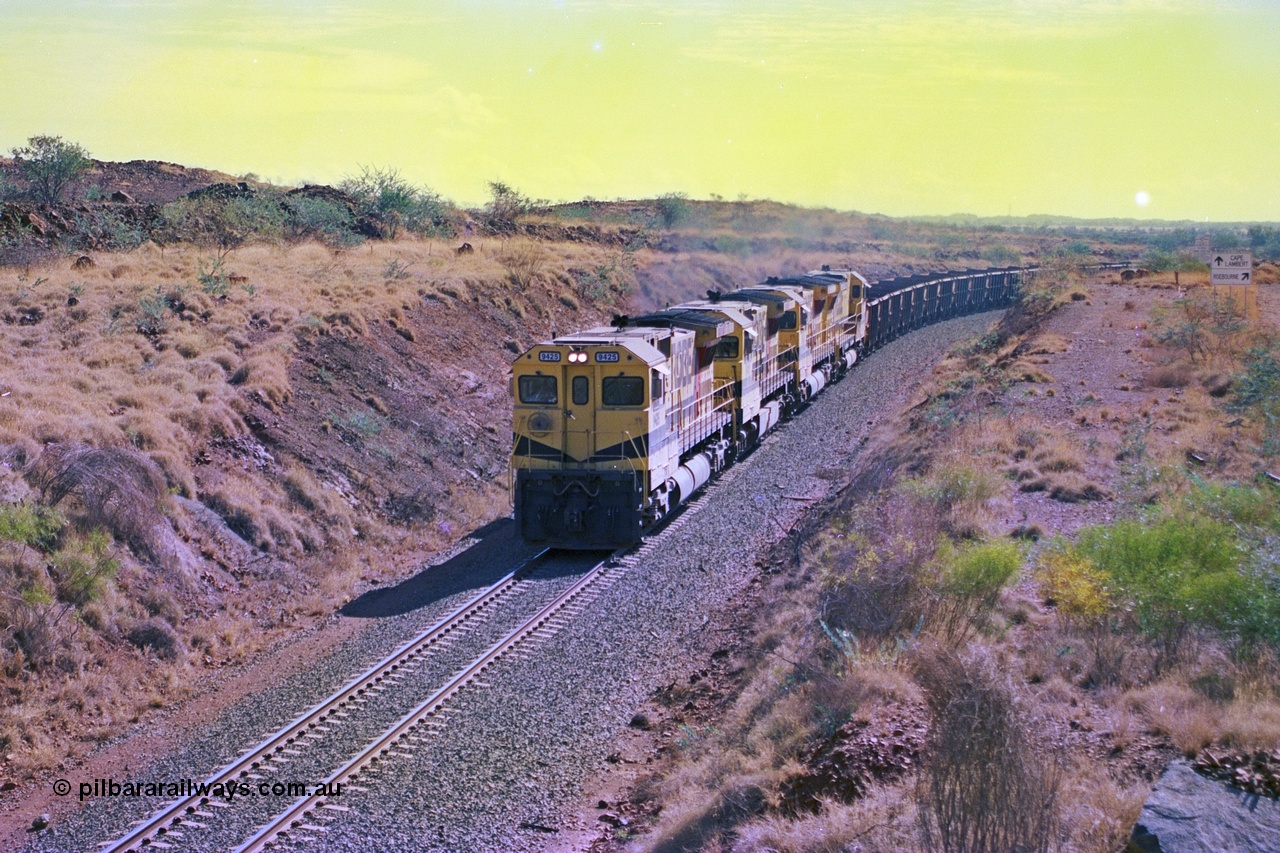 247-31
Near Cooya Pooya at the 37.5 km on the Robe River Cape Lambert line an empty train is about to pass under the town water supply pipeline and pass through Lockyer Gap behind the standard Robe power of quad CM40-8M or Dash 8 locomotives led by 9425 which is a Goninan WA ALCo to GE rebuild CM40-8M with serial 6266-8 / 89-85 from August 1989 riding on Hi-Ad bogies and was originally an AE Goodwin built M636 ALCo serial C-6041-4 and built new for Mt Newman Mining (later BHP Iron Ore) in April 1970 and numbered 5468, sold to Robe and delivered by road 17th August 1982. Location is [url=https://goo.gl/maps/nLyndU6bg2HA5SZX6]here[/url].22nd May 2002.
Keywords: 9425;Goninan;GE;CM40-8M;6266-8/89-85;rebuild;AE-Goodwin;ALCo;M636;G-6041-4;