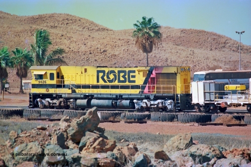 247-01
Cape Lambert, Robe River's 9426 a Comeng WA rebuild from ALCo Schenectady NY model C636 serial 3499-3 originally built in January 1968 for Pennsylvania as #6332, Penn Central 6332 and finally Conrail 6782. Purchased in 1986 and rebuilt by Comeng WA into C636R before delivery to Robe in November 1986. This loco also went on to become DR 8401 for construction of FMG's railway in 2007-08. Seen here in the South Yard waiting to drag a loaded rake down to the car dumper. Approximate location of train is [url=https://goo.gl/maps/tRtaJxMULpjBhtqa8]here[/url]. 22nd May 2002.
Keywords: 9426;Comeng-WA;C636R;WA143-1;rebuild;ALCo;Schenectady-NY;C636;Conrail;6782;3499-3;