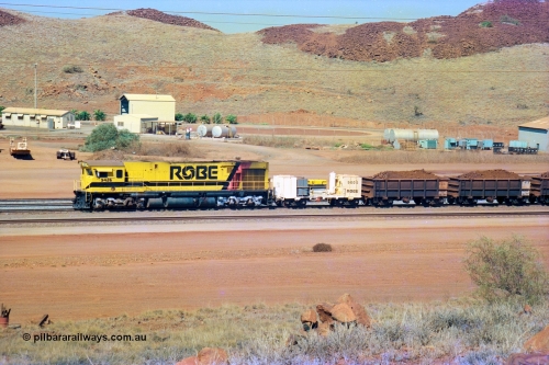 247-12
Cape Lambert, Robe River's 9426 a Comeng WA rebuild from ALCo Schenectady NY model C636 serial 3499-3 originally built in January 1968 for Pennsylvania as #6332, Penn Central 6332 and finally Conrail 6782. Purchased in 1986 and rebuilt by Comeng WA into C636R before delivery to Robe in November 1986. This loco also went on to become DR 8401 for construction of FMG's railway in 2007-08. Seen here in the South Yard dragging a loaded rake down to the car dumper. Approximate location of train is [url=https://goo.gl/maps/L8Y75jkpyVdps6pg6]here[/url]. 22nd May 2002.
Keywords: 9426;Comeng-WA;C636R;WA143-1;rebuild;ALCo;Schenectady-NY;C636;Conrail;6782;3499-3;