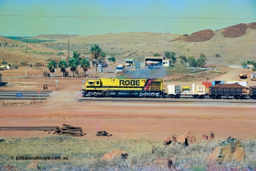 247-19
Cape Lambert, Robe River's 9426 a Comeng WA rebuild from ALCo Schenectady NY model C636 serial 3499-3 originally built in January 1968 for Pennsylvania as #6332, Penn Central 6332 and finally Conrail 6782. Purchased in 1986 and rebuilt by Comeng WA into C636R before delivery to Robe in November 1986. This loco also went on to become DR 8401 for construction of FMG's railway in 2007-08. Seen here dragging a loaded 101 waggon rake down to the car dumper at Bells Crossing. Approximate location of train is [url=https://goo.gl/maps/gFwTfdqvJ3c21N4u7]here[/url]. 22nd May 2002.
Keywords: 9426;Comeng-WA;C636R;WA143-1;rebuild;ALCo;Schenectady-NY;C636;Conrail;6782;3499-3;