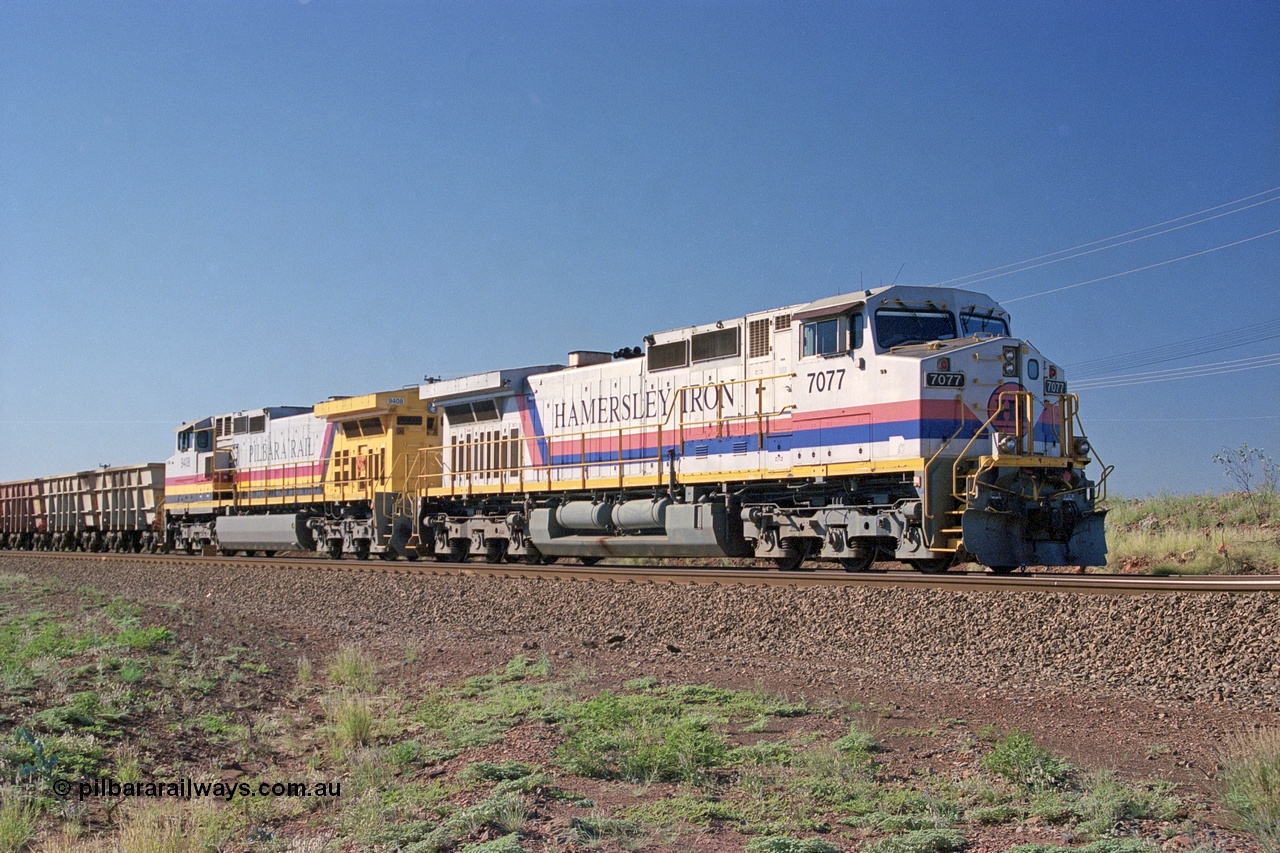 248-01
Dingo Siding on the Hamersley Iron railway at the 39 km with an empty train headed up by a pair of General Electric built Dash 9-44CW units 7077 serial 47756 from the original first order in the Pepsi Can livery and 9408 serial 54158 from the fourth order in the Pilbara Rail livery with Robe ownership markings. Approximate [url=https://goo.gl/maps/Jv752bD5KXv28oUV7]location[/url]. 24th April 2004.
Keywords: 7077;GE;Dash-9-44CW;47756;