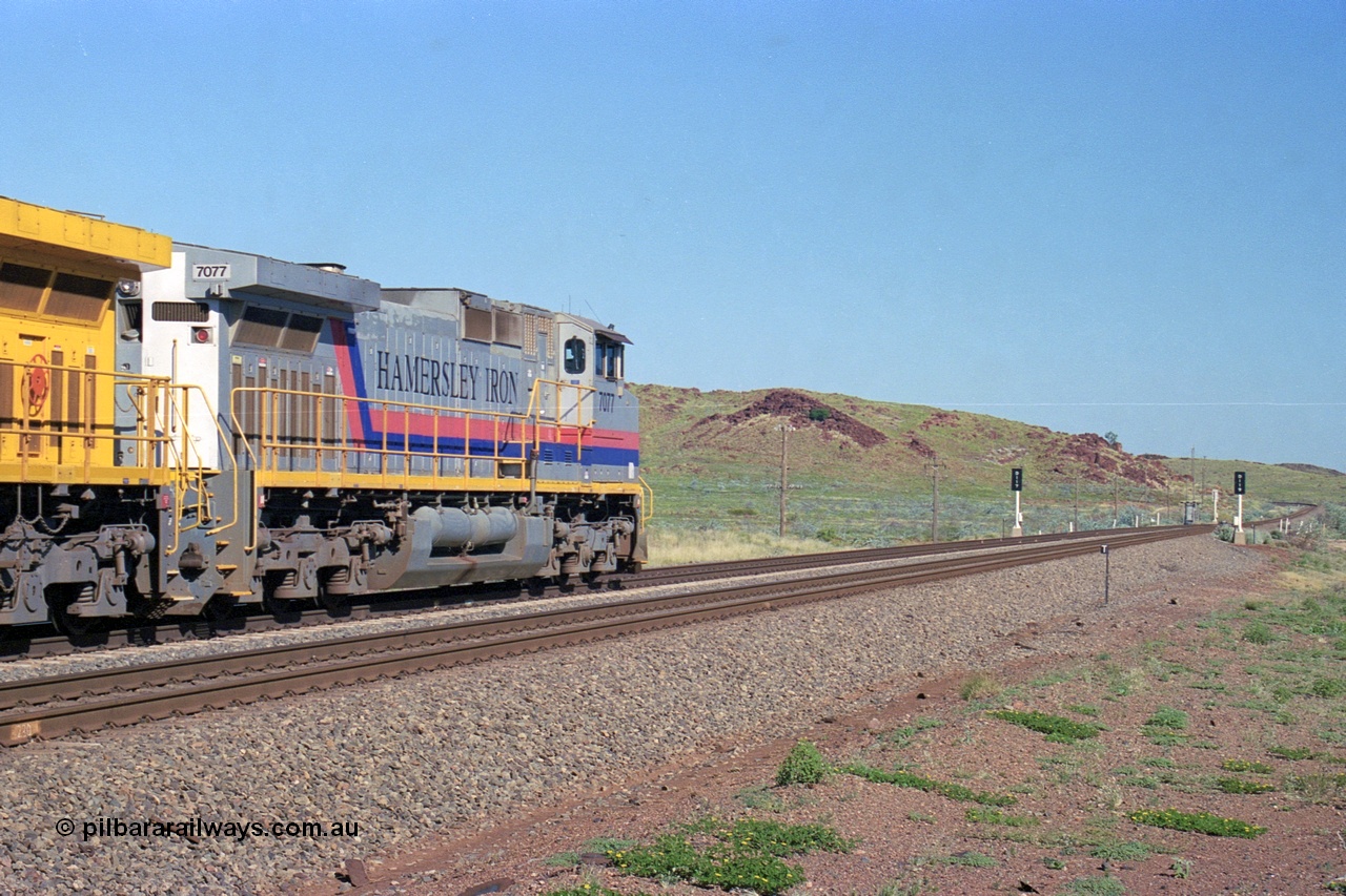 248-12
Dingo Siding on the Hamersley Iron railway at the 39 km with an empty train headed up by a pair of General Electric built Dash 9-44CW units 7077 serial 47756 from the original first order in the Pepsi Can livery and 9408 serial 54158 from the fourth order in the Pilbara Rail livery with Robe ownership markings powers away to the south with the signal marker boards are in the distance. Approximate [url=https://goo.gl/maps/Jv752bD5KXv28oUV7]location[/url]. 24th April 2004.
Keywords: 7077;GE;Dash-9-44CW;47756;