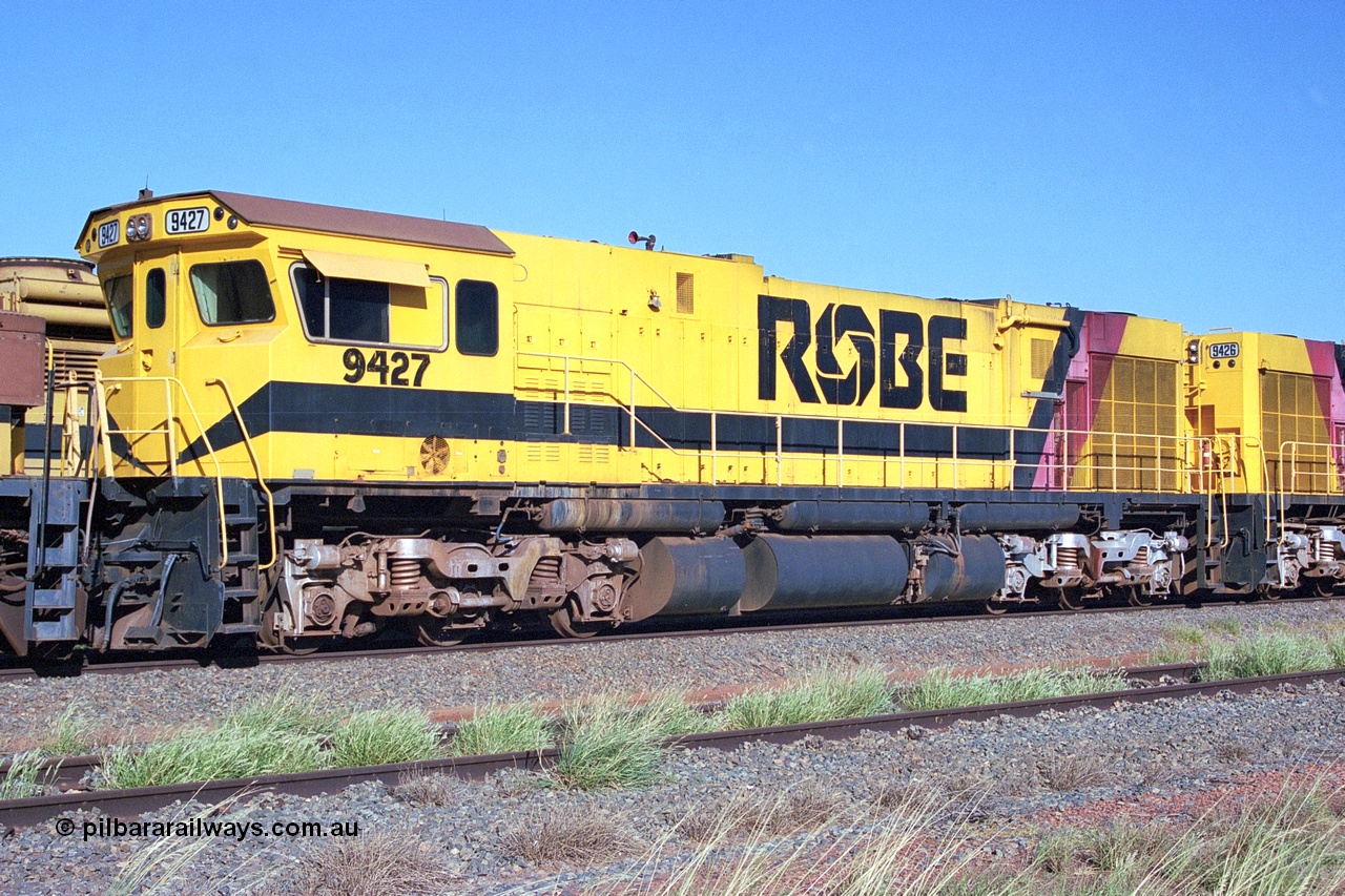 248-17
Seven Mile yard, stored Robe River ALCo locomotives at the south end of the Hamersley Iron Seven Mile yard on roads N2 and N3. On road N2 is 9427 a Comeng WA C636R rebuild from ALCo Schenectady NY model C636 serial 3499-2 originally built in January 1968 for Pennsylvania Railroad as #6331, Penn Central 6331 and finally Conrail 6781. Purchased in 1986 and rebuilt by Comeng WA into C636R before delivery to Robe in January 1987. This loco also went on to become DR 8403 for construction of FMG's railway in 2007-08. Approximate [url=https://goo.gl/maps/CXwAreRPb2RymQ9m9]location[/url]. 24th April 2004.
Keywords: 9427;Comeng-WA;C636R;WA143-2;rebuild;ALCo;Schenectady-NY;C636;Conrail;6781;3499-2;