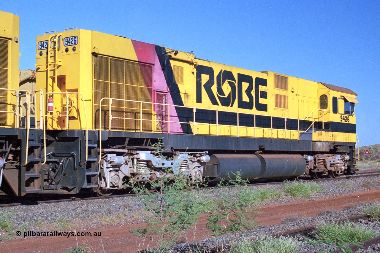 248-24
Seven Mile yard, stored Robe River ALCo locomotives at the south end of the Hamersley Iron Seven Mile yard on roads N2 and N3. On road N2 is 9426 a Comeng WA C636R rebuild from ALCo Schenectady NY model C636 serial 3499-3 originally built in January 1968 for Pennsylvania Railroad as #6332, Penn Central 6332 and finally Conrail 6782. Purchased in 1986 and rebuilt by Comeng WA into C636R before delivery to Robe in November 1986. This loco also went on to become DR 8401 for construction of FMG's railway in 2007-08. Behind it is sister unit 9427 and ALCo M636 9412. Approximate [url=https://goo.gl/maps/CXwAreRPb2RymQ9m9]location[/url]. 24th April 2004.
Keywords: 9426;Comeng-WA;C636R;WA143-1;rebuild;ALCo;Schenectady-NY;C636;Conrail;6782;3499-3;