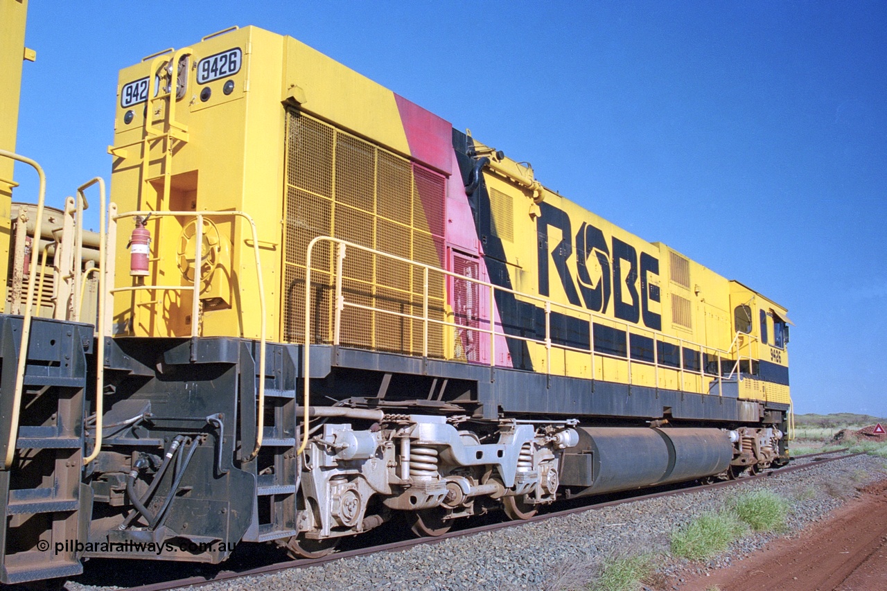 248-25
Seven Mile yard, stored Robe River ALCo locomotives at the south end of the Hamersley Iron Seven Mile yard on roads N2 and N3. On road N2 is 9426 a Comeng WA C636R rebuild from ALCo Schenectady NY model C636 serial 3499-3 originally built in January 1968 for Pennsylvania Railroad as #6332, Penn Central 6332 and finally Conrail 6782. Purchased in 1986 and rebuilt by Comeng WA into C636R before delivery to Robe in November 1986. This loco also went on to become DR 8401 for construction of FMG's railway in 2007-08. Behind it is sister unit 9427 and ALCo M636 9412. Approximate [url=https://goo.gl/maps/CXwAreRPb2RymQ9m9]location[/url]. 24th April 2004.
Keywords: 9426;Comeng-WA;C636R;WA143-1;rebuild;ALCo;Schenectady-NY;C636;Conrail;6782;3499-3;