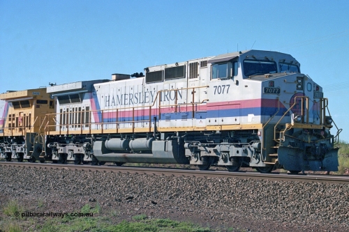 248-03
Dingo Siding on the Hamersley Iron railway at the 39 km with an empty train headed up by a pair of General Electric built Dash 9-44CW units 7077 serial 47756 from the original first order in the Pepsi Can livery from 1994 still looking good some ten years later. Approximate [url=https://goo.gl/maps/Jv752bD5KXv28oUV7]location[/url]. April 24, 2004.
Keywords: 7077;GE;Dash-9-44CW;47756;