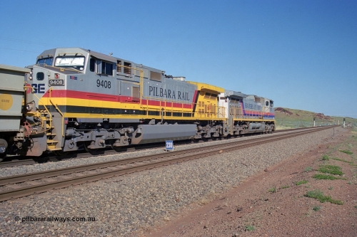 248-09
Dingo Siding on the Hamersley Iron railway at the 39 km with an empty train headed up by a pair of General Electric built Dash 9-44CW units 7077 serial 47756 from the original first order in the Pepsi Can livery and 9408 serial 54158 from the fourth order in the Pilbara Rail livery with Robe ownership markings. The signal marker boards are in the distance. Approximate [url=https://goo.gl/maps/Jv752bD5KXv28oUV7]location[/url]. April 24, 2004.
Keywords: 9408;GE;Dash-9-44CW;54158;