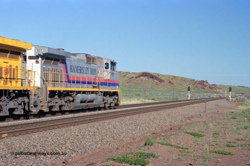 248-12
Dingo Siding on the Hamersley Iron railway at the 39 km with an empty train headed up by a pair of General Electric built Dash 9-44CW units 7077 serial 47756 from the original first order in the Pepsi Can livery and 9408 serial 54158 from the fourth order in the Pilbara Rail livery with Robe ownership markings powers away to the south with the signal marker boards are in the distance. Approximate [url=https://goo.gl/maps/Jv752bD5KXv28oUV7]location[/url]. April 24, 2004.
Keywords: 7077;GE;Dash-9-44CW;47756;