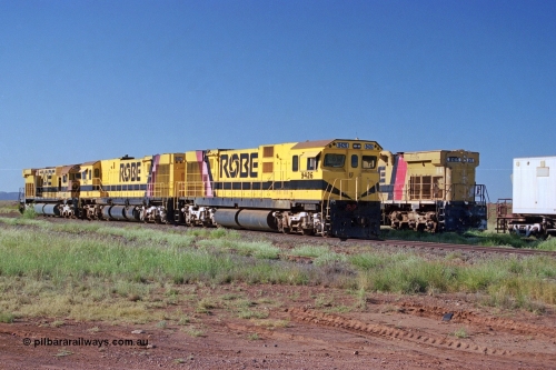 248-15
Seven Mile yard, stored Robe River ALCo locomotives at the south end of the Hamersley Iron Seven Mile yard on roads N2 and N3. On road N2 is 9426 a Comeng WA C636R rebuild from ALCo Schenectady NY model C636 serial 3499-3 originally built in January 1968 for Pennsylvania Railroad as #6332, Penn Central 6332 and finally Conrail 6782. Purchased in 1986 and rebuilt by Comeng WA into C636R before delivery to Robe in November 1986. This loco also went on to become DR 8401 for construction of FMG's railway in 2007-08. Behind it is sister unit 9427 and ALCo M636 9412. Approximate [url=https://goo.gl/maps/CXwAreRPb2RymQ9m9]location[/url]. April 24, 2004.
Keywords: 9426;Comeng-WA;C636R;WA143-1;rebuild;ALCo;Schenectady-NY;C636;Conrail;6782;3499-3;