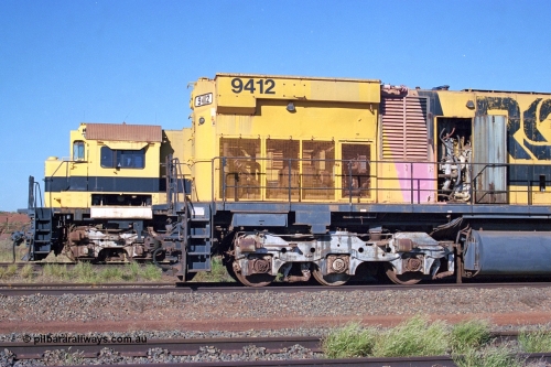 248-19
Seven Mile yard, stored Robe River ALCo locomotives at the south end of the Hamersley Iron Seven Mile yard on roads N2 and N3. On N2 is a radiator view of AE Goodwin built ALCo M636 unit 9412 serial G-6060-3 from December 1971 and originally numbered 262.003 during construction and then 1712. Behind it on N3 is the cab of 9416 also an AE Goodwin built ALCo M636 serial G-6046-16 from January 1973 and originally numbered 1716. Approximate [url=https://goo.gl/maps/CXwAreRPb2RymQ9m9]location[/url]. April 24, 2004.
Keywords: 9412;AE-Goodwin;MLW-ALCo;M636;G6060-3;