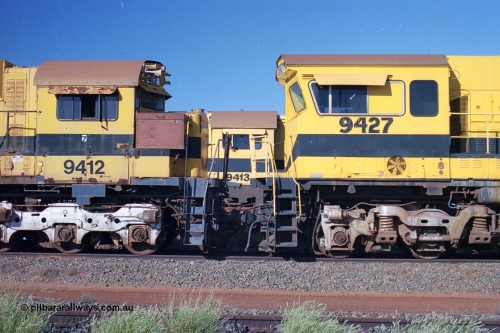 248-22
Seven Mile yard, stored Robe River ALCo locomotives at the south end of the Hamersley Iron Seven Mile yard on roads N2 and N3. On N2 is a cab comparison between AE Goodwin built ALCo M636 unit 9412 serial G-6060-3 from December 1971 and originally numbered 262.003 during construction and then 1712 on MLW Dofasco bogies with C636R units 9427 a Comeng WA C636R rebuild from ALCo Schenectady NY model C636 serial 3499-2 originally built in January 1968 for Pennsylvania Railroad as #6331, Penn Central 6331 and finally Conrail 6781. Purchased in 1986 and rebuilt by Comeng WA into C636R before delivery to Robe in January 1987 riding on the ALCo Hi-Ad bogie. This loco also went on to become DR 8403 for construction of FMG's railway in 2007-08. Behind it on N3 is 9413. Approximate [url=https://goo.gl/maps/CXwAreRPb2RymQ9m9]location[/url]. April 24, 2004.
Keywords: 9412;AE-Goodwin;MLW-ALCo;M636;G6060-3;