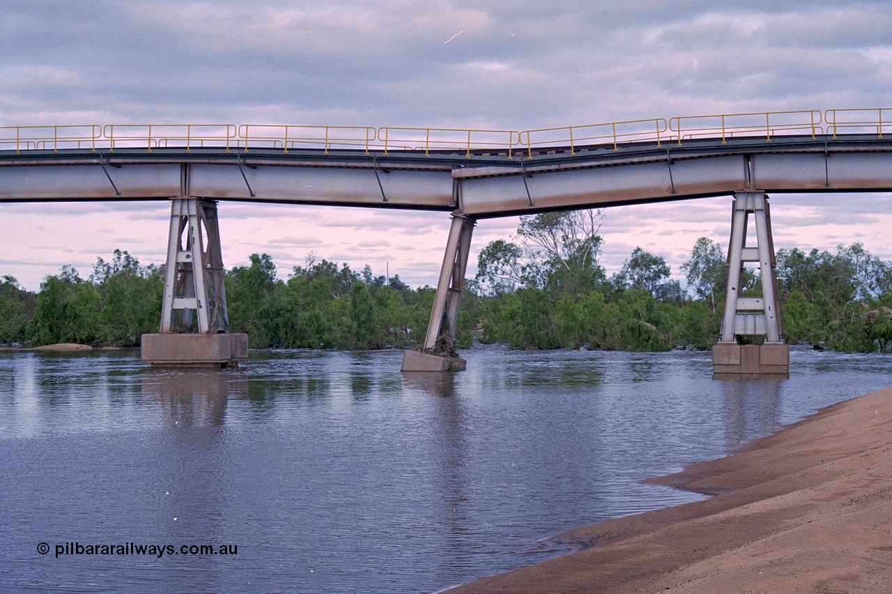 249-08
Yule River bridge looking east upstream the third pier from the southern end was undermined by flood waters from Tropical Cyclone John in December 1999. The rail line was closed for two weeks while repairs were effected. Approximate [url=https://goo.gl/maps/phCWr8u1xnuBdzwj6]location[/url].
