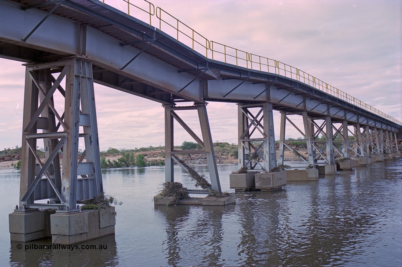 249-11
Yule River bridge looking north west downstream the third pier from the southern end was undermined by flood waters from Tropical Cyclone John in December 1999. The rail line was closed for two weeks while repairs were effected. Approximate [url=https://goo.gl/maps/phCWr8u1xnuBdzwj6]location[/url].
