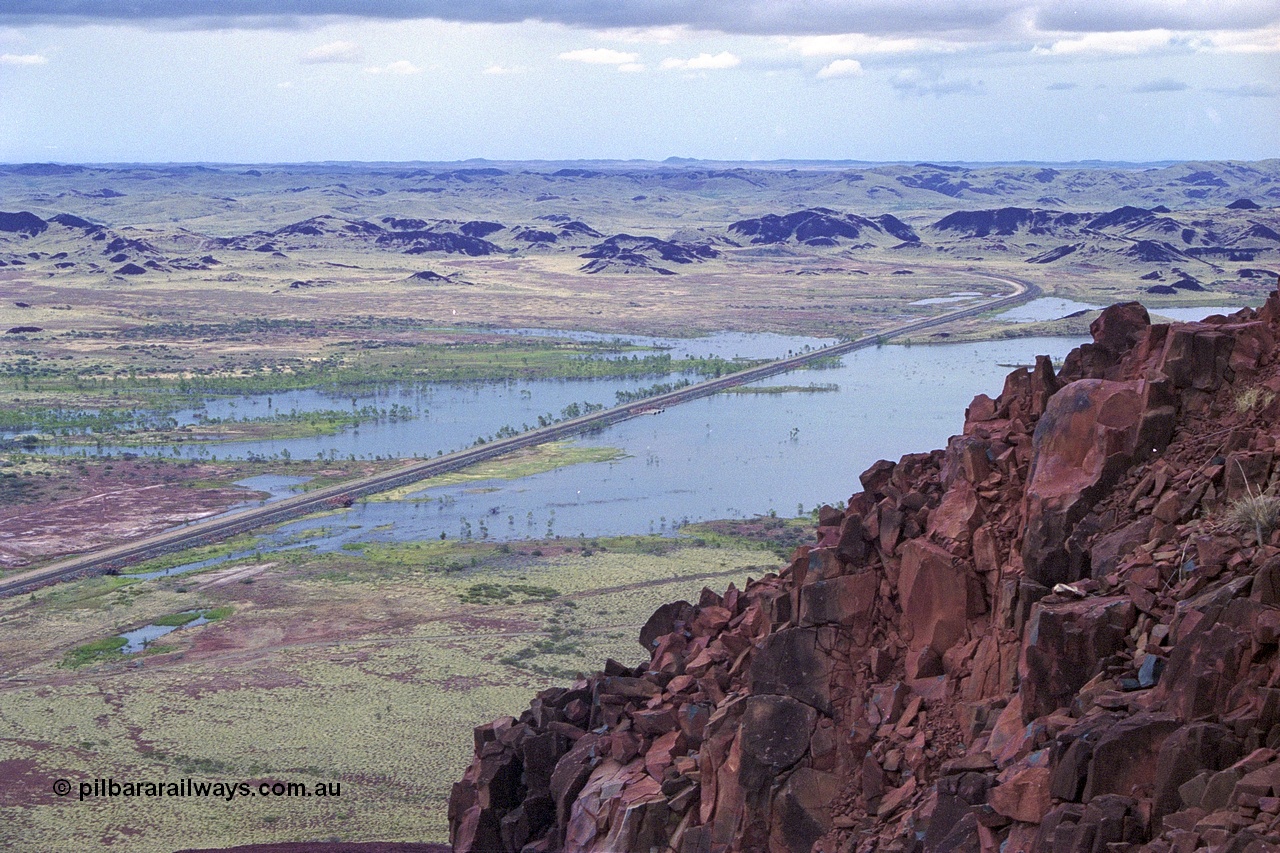 249-17
Table Hill on the Robe River railway line, looking in a northerly direction as the railway line snakes north and heads through Lockyer Gap towards Cape Lambert. Following a very wet 1999 cyclone season Lake Poongkaliyarra is very full. Approximate [url=https://goo.gl/maps/KVjEPms558wdoi2o8]location[/url].
