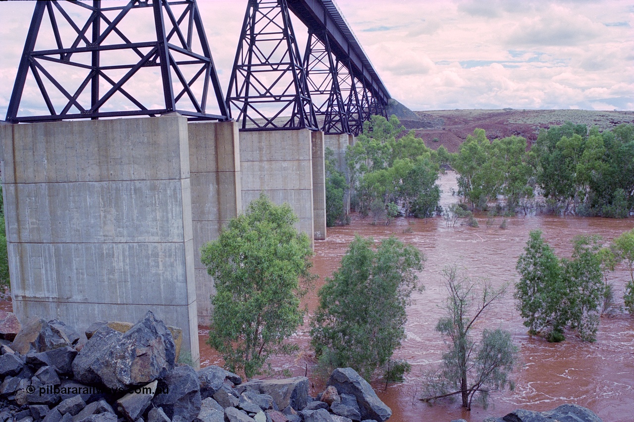 249-20
Fortescue River Bridge on the Robe River line at the 115.8 km in flood looking south following Cyclone John on 18th December 1999. Approximate [url=https://goo.gl/maps/CDTmtMLJewGrMq699]location[/url].
