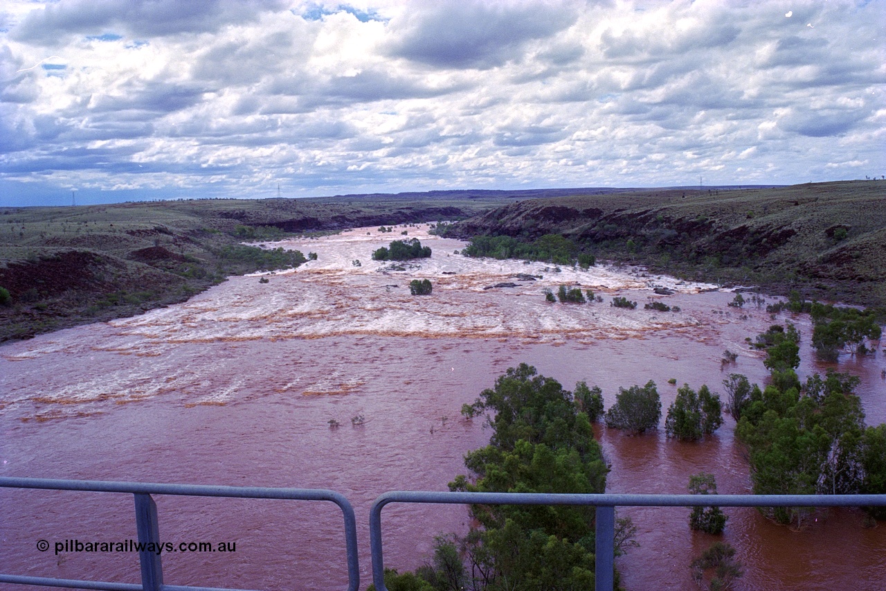 249-24
Fortescue River Bridge on the Robe River line at the 115.8 km in flood looking downstream to the west from the middle of the bridge following Cyclone John on 18th December 1999. Approximate [url=https://goo.gl/maps/x9Cwp468FXgohtvK8]location[/url].
