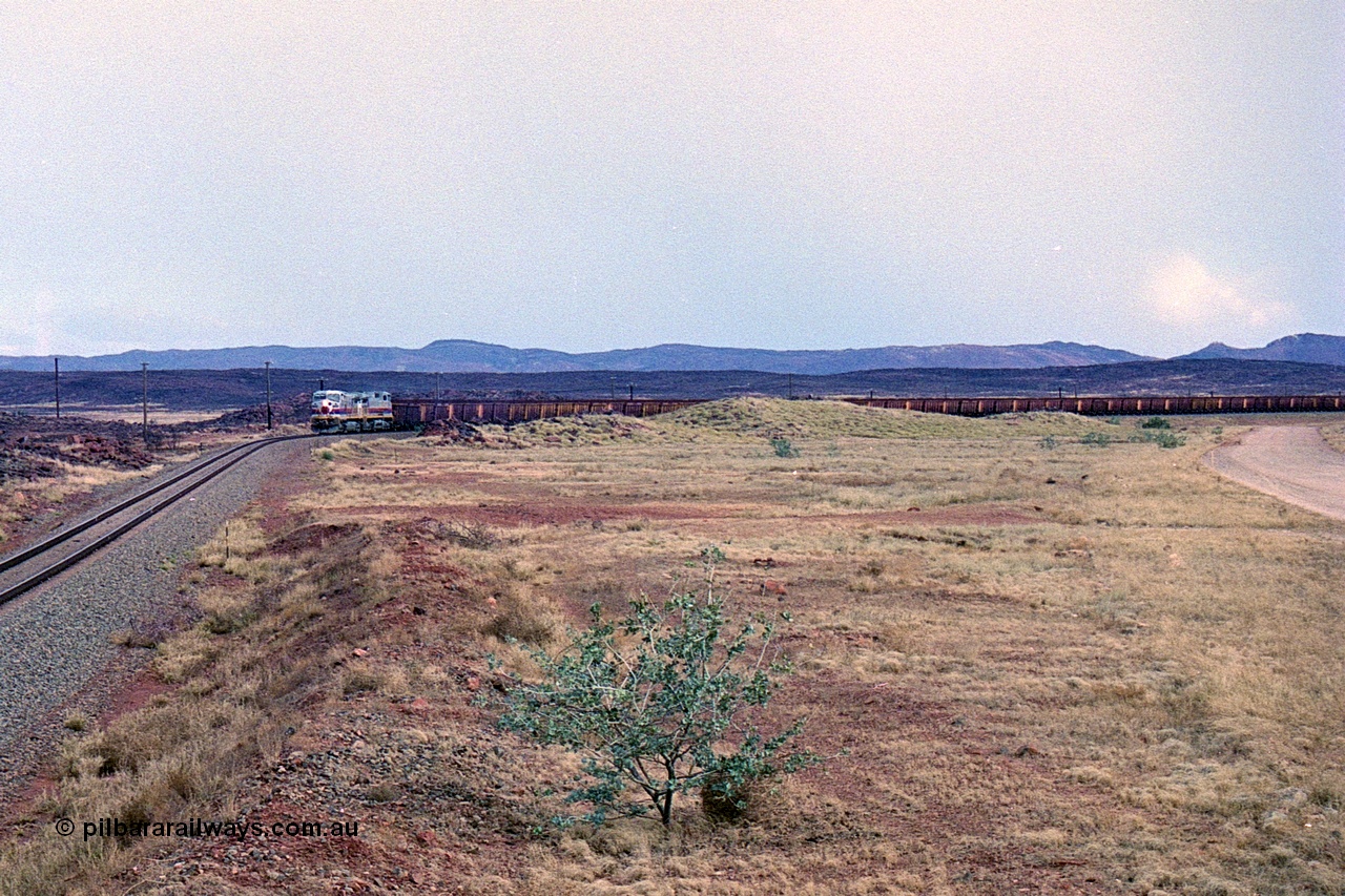249-26
A loaded Hamersley Iron train runs across the plains north of Dugite Siding near the 70 km as it nears the destination of its cargo. Approximate [url=https://goo.gl/maps/UUfj15vTkvBaPCaw8]location[/url]. 18th December 1999.
