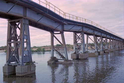 249-11
Yule River bridge looking north west downstream the third pier from the southern end was undermined by flood waters from Tropical Cyclone John in December 1999. The rail line was closed for two weeks while repairs were effected. Approximate [url=https://goo.gl/maps/phCWr8u1xnuBdzwj6]location[/url].
