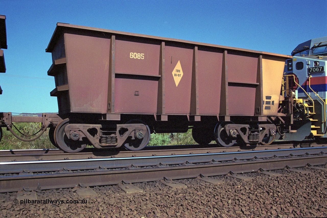 250-07
Pelican Siding on the Hamersley Iron Tom Price line about the 208 km empty ore waggon 6085 is an example of the units built by Tomlinson Steel WA is a slave waggon of the pair and shows the re-sheeting paint symbol to indicate that all four sides and the floor have been replaced. 21st October 2000.
Keywords: 6085;Tomlinson-Steel;M-series;