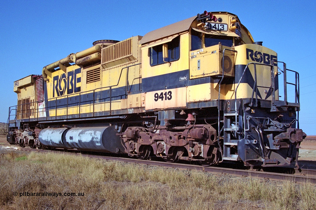 250-21
Cape Lambert yard on the Load Box Spur is recently stored Robe River AE Goodwin built ALCo M636 unit 9413 serial G6060-4 from December 1971, originally numbered 262.004 during construction, renumbered to 86-14-1713 with number boards 1713 and finally 9413. The ducting on the hood is the air to air intercooler modifications. 22nd October 2000.
Keywords: 9413;AE-Goodwin;ALCo;M636;G6060-4;