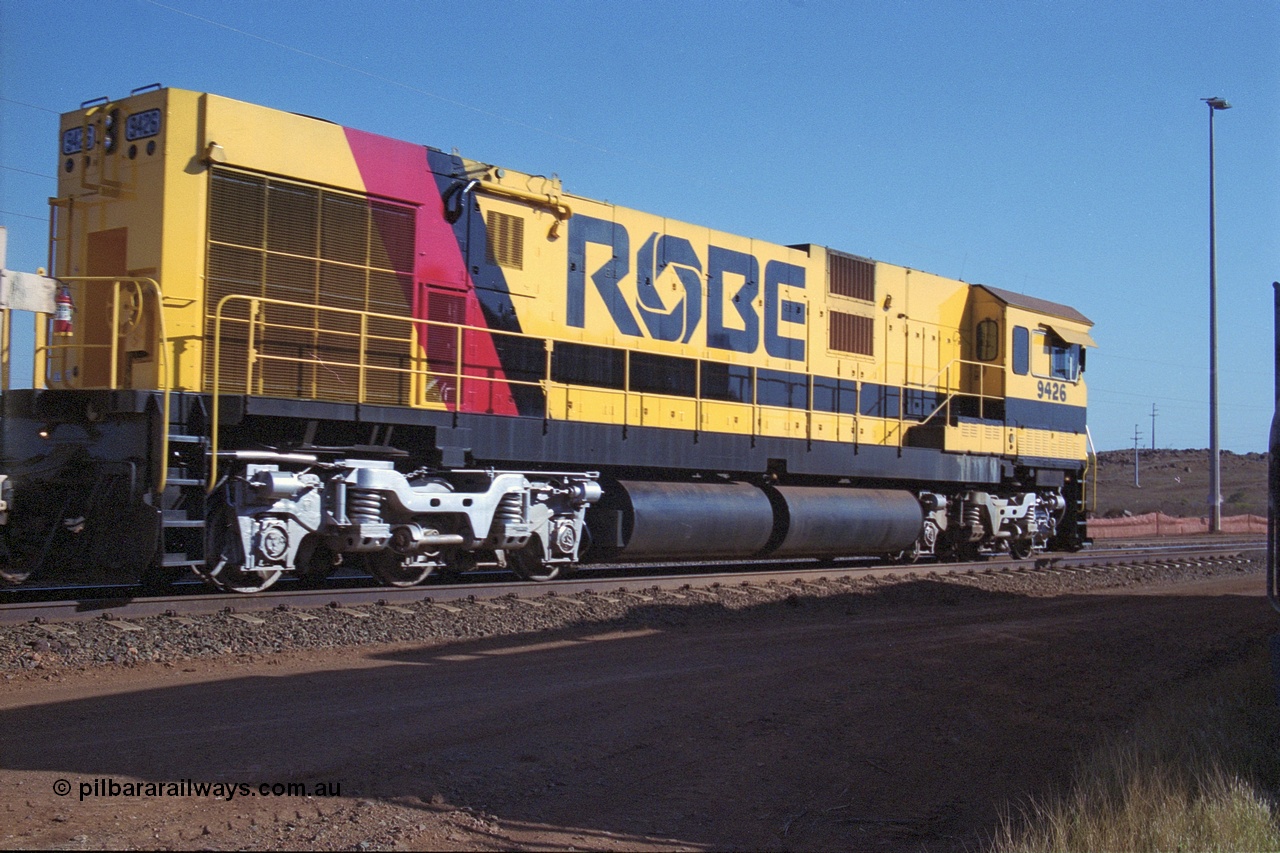 250-25
Cape Lambert South Yard and Robe River's 9426 a Comeng WA rebuild from ALCo Schenectady NY model C636 serial 3499-3 originally built in January 1968 for Pennsylvania as #6332, Penn Central 6332 and finally Conrail 6782. Purchased in 1986 and rebuilt by Comeng WA into C636R before delivery to Robe in November 1986. This loco also went on to become DR 8401 for construction of FMG's railway in 2007-08. Seen here in the South Yard dragging a loaded rake down to the car dumper. 22nd October 2000.
Keywords: 9426;Comeng-WA;C636R;WA143-1;rebuild;ALCo;Schenectady-NY;C636;Conrail;6782;3499-3;