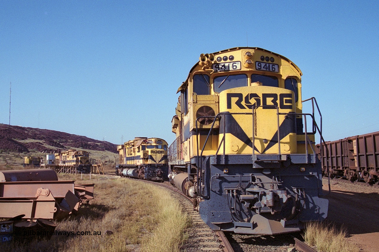 250-28
Cape Lambert Load Box Spur with Robe River's four remaining ALCo units recently stored out of service. 9416, 9413, 9515 in the load box and 9412 in the distance. 22nd October 2000.
Keywords: 9416;AE-Goodwin;ALCo;M636;G6046-16;