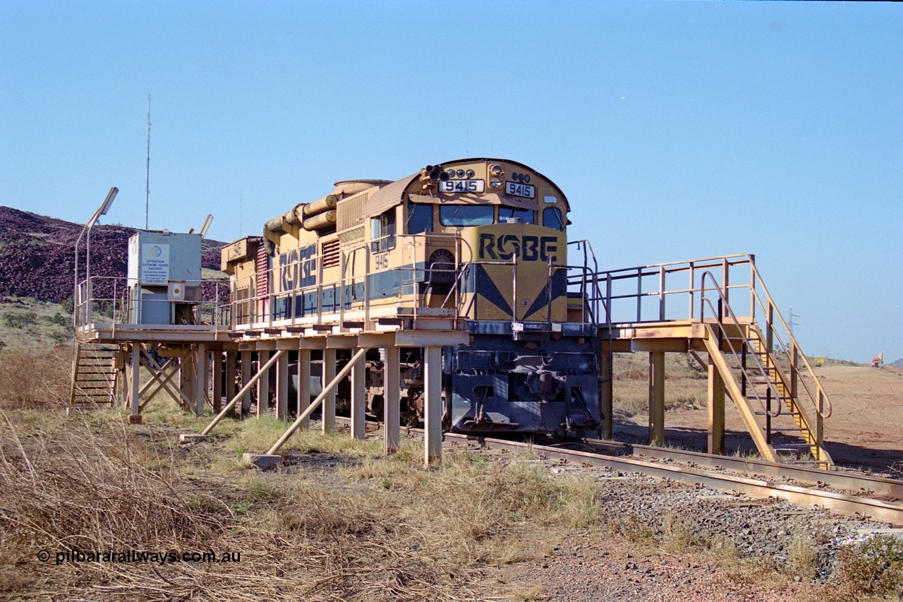 250-31
Cape Lambert yard in the Load Box is recently stored Robe River AE Goodwin built ALCo M636 unit 9415 serial G6060-6 from February 1973 and was an extension of the original order and delivered with cab side numbering of 86-14-1715 and number boards as 1715. The ducting on the hood is the air to air intercooler modifications. 22nd October 2000.
Keywords: 9415;AE-Goodwin;ALCo;M636;G6060-6;