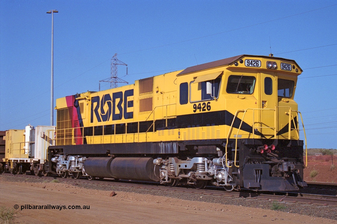 250-32
Cape Lambert South Yard and Robe River's 9426 a Comeng WA rebuild from ALCo Schenectady NY model C636 serial 3499-3 originally built in January 1968 for Pennsylvania as #6332, Penn Central 6332 and finally Conrail 6782. Purchased in 1986 and rebuilt by Comeng WA into C636R before delivery to Robe in November 1986. This loco also went on to become DR 8401 for construction of FMG's railway in 2007-08. Seen here in the South Yard dragging a loaded rake down to the car dumper. 22nd October 2000.
Keywords: 9426;Comeng-WA;C636R;WA143-1;rebuild;ALCo;Schenectady-NY;C636;Conrail;6782;3499-3;