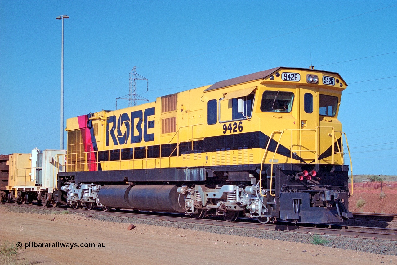 250-33
Cape Lambert South Yard and Robe River's 9426 a Comeng WA rebuild from ALCo Schenectady NY model C636 serial 3499-3 originally built in January 1968 for Pennsylvania as #6332, Penn Central 6332 and finally Conrail 6782. Purchased in 1986 and rebuilt by Comeng WA into C636R before delivery to Robe in November 1986. This loco also went on to become DR 8401 for construction of FMG's railway in 2007-08. Seen here in the South Yard dragging a loaded rake down to the car dumper. 22nd October 2000.
Keywords: 9426;Comeng-WA;C636R;WA143-1;rebuild;ALCo;Schenectady-NY;C636;Conrail;6782;3499-3;