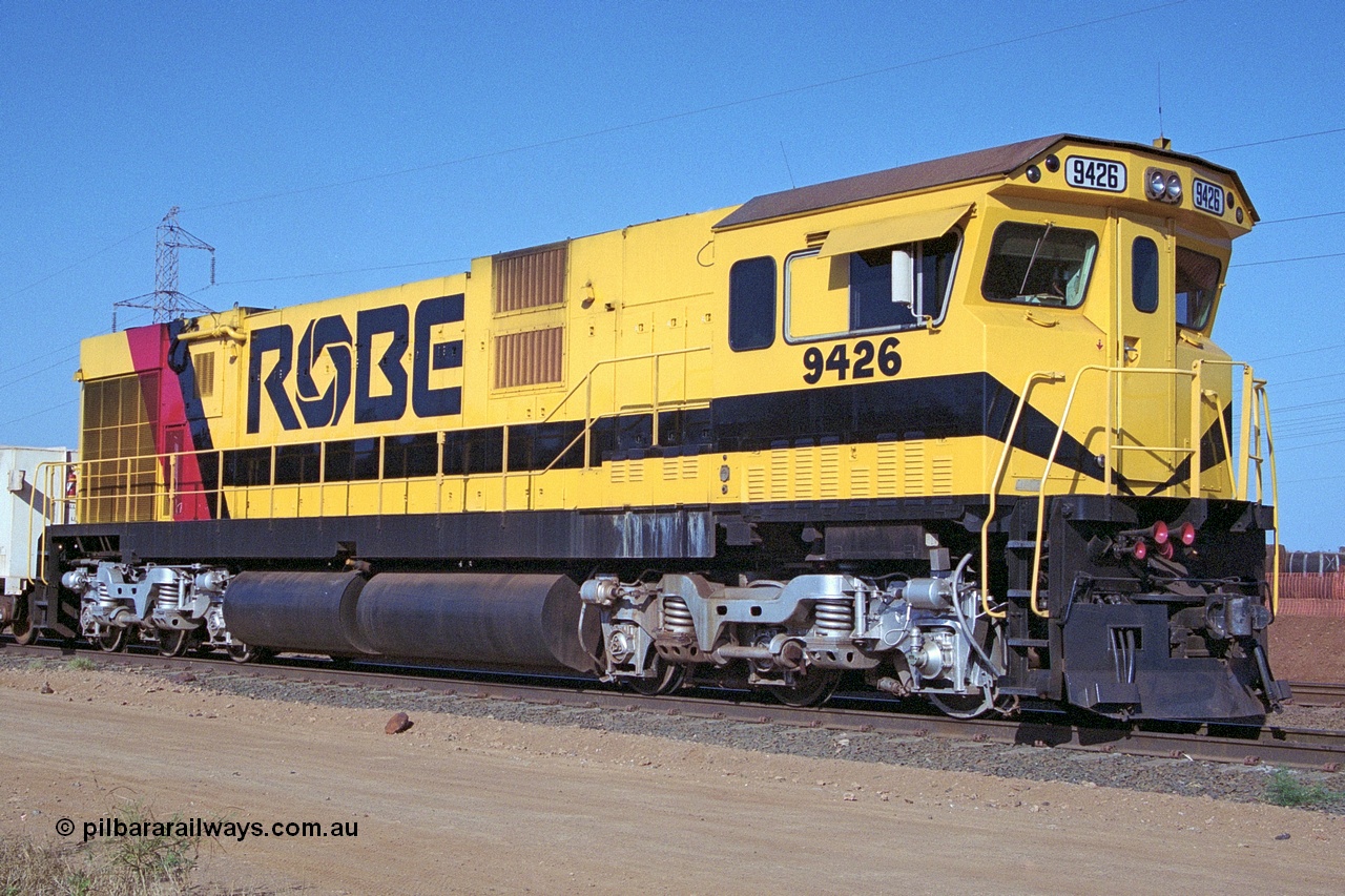 250-35
Cape Lambert South Yard and Robe River's 9426 a Comeng WA rebuild from ALCo Schenectady NY model C636 serial 3499-3 originally built in January 1968 for Pennsylvania as #6332, Penn Central 6332 and finally Conrail 6782. Purchased in 1986 and rebuilt by Comeng WA into C636R before delivery to Robe in November 1986. This loco also went on to become DR 8401 for construction of FMG's railway in 2007-08. Seen here in the South Yard dragging a loaded rake down to the car dumper. 22nd October 2000.
Keywords: 9426;Comeng-WA;C636R;WA143-1;rebuild;ALCo;Schenectady-NY;C636;Conrail;6782;3499-3;