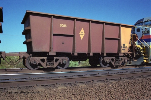 250-07
Pelican Siding on the Hamersley Iron Tom Price line about the 208 km empty ore waggon 6085 is an example of the units built by Tomlinson Steel WA is a slave waggon of the pair and shows the re-sheeting paint symbol to indicate that all four sides and the floor have been replaced. 21st October 2000.
Keywords: 6085;M-series;Tomlinson-Steel;HI-ore-waggon;