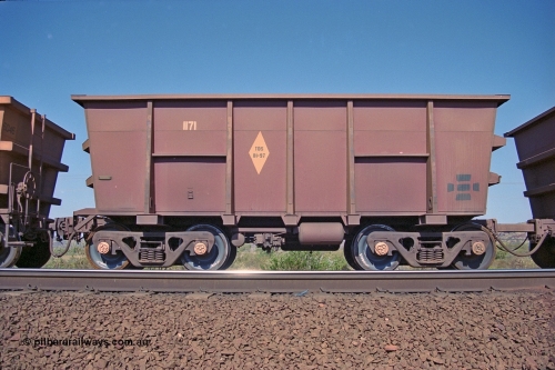 250-08
Pelican Siding on the Hamersley Iron Tom Price line about the 208 km empty ore waggon 1171 is an example of the units built by Tomlinson Steel WA and is a control or master waggon of the pair and shows the re-sheeting paint symbol to indicate that all four sides and the floor have been replaced. Note the square bar coupling on the right hand side to the slave waggon 6085, HI run what they call 'Married Pairs'. 21st October 2000.
Keywords: 1171;M-series;Tomlinson-Steel;HI-ore-waggon;