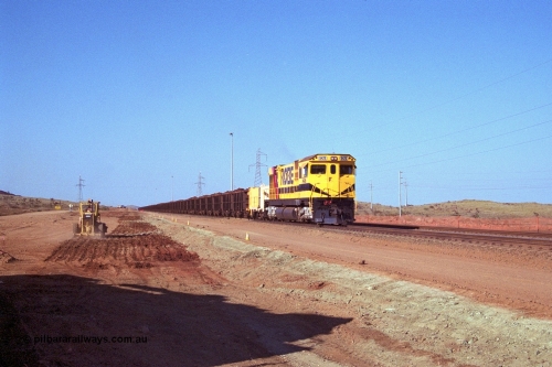 250-22
Cape Lambert South Yard and Robe River's 9426 a Comeng WA rebuild from ALCo Schenectady NY model C636 serial 3499-3 originally built in January 1968 for Pennsylvania as #6332, Penn Central 6332 and finally Conrail 6782. Purchased in 1986 and rebuilt by Comeng WA into C636R before delivery to Robe in November 1986. This loco also went on to become DR 8401 for construction of FMG's railway in 2007-08. Seen here in the South Yard dragging a loaded rake down to the car dumper as yard expansion works are underway to the left. 22nd October 2000.
Keywords: 9426;Comeng-WA;C636R;WA143-1;rebuild;ALCo;Schenectady-NY;C636;Conrail;6782;3499-3;