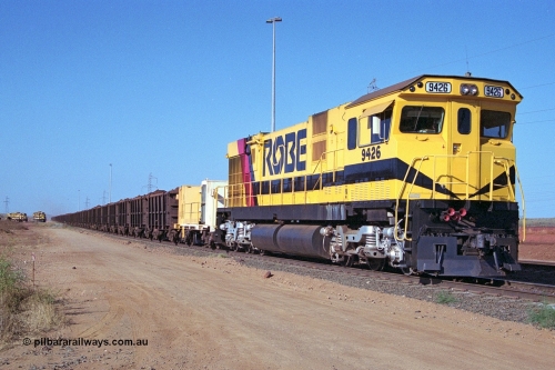 250-34
Cape Lambert South Yard and Robe River's 9426 a Comeng WA rebuild from ALCo Schenectady NY model C636 serial 3499-3 originally built in January 1968 for Pennsylvania as #6332, Penn Central 6332 and finally Conrail 6782. Purchased in 1986 and rebuilt by Comeng WA into C636R before delivery to Robe in November 1986. This loco also went on to become DR 8401 for construction of FMG's railway in 2007-08. Seen here in the South Yard dragging a loaded rake down to the car dumper. 22nd October 2000.
Keywords: 9426;Comeng-WA;C636R;WA143-1;rebuild;ALCo;Schenectady-NY;C636;Conrail;6782;3499-3;