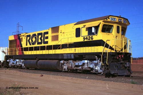 250-36
Cape Lambert South Yard and Robe River's 9426 a Comeng WA rebuild from ALCo Schenectady NY model C636 serial 3499-3 originally built in January 1968 for Pennsylvania as #6332, Penn Central 6332 and finally Conrail 6782. Purchased in 1986 and rebuilt by Comeng WA into C636R before delivery to Robe in November 1986. This loco also went on to become DR 8401 for construction of FMG's railway in 2007-08. Seen here in the South Yard dragging a loaded rake down to the car dumper. 22nd October 2000.
Keywords: 9426;Comeng-WA;C636R;WA143-1;rebuild;ALCo;Schenectady-NY;C636;Conrail;6782;3499-3;
