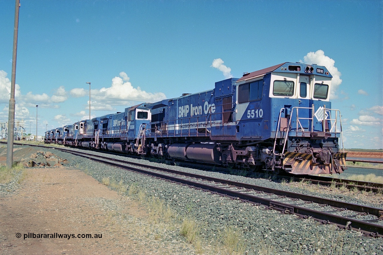 251-00
Nelson Point, BHP's retired Goninan WA's ALCo C636 to GE C36-7M rebuilds, these were the first time in the world that an ALCo C636 had been rebuilt into an GE C36-7, are lined up near the service shop awaiting their fate. The line is 5510, 5506, 5508, 5512, 5513, 5507, 5509, 5511, and, 5513. They had recently been displaced due to the arrival of the AC6000 units which also took their name plates. Only two units would go on to survive 5507 and 5508. 22nd April 2000.
Keywords: 5510;Goninan;GE;C36-7M;4839-07/87-075;rebuild;AE-Goodwin;ALCO;C636;5458;G6027-2;