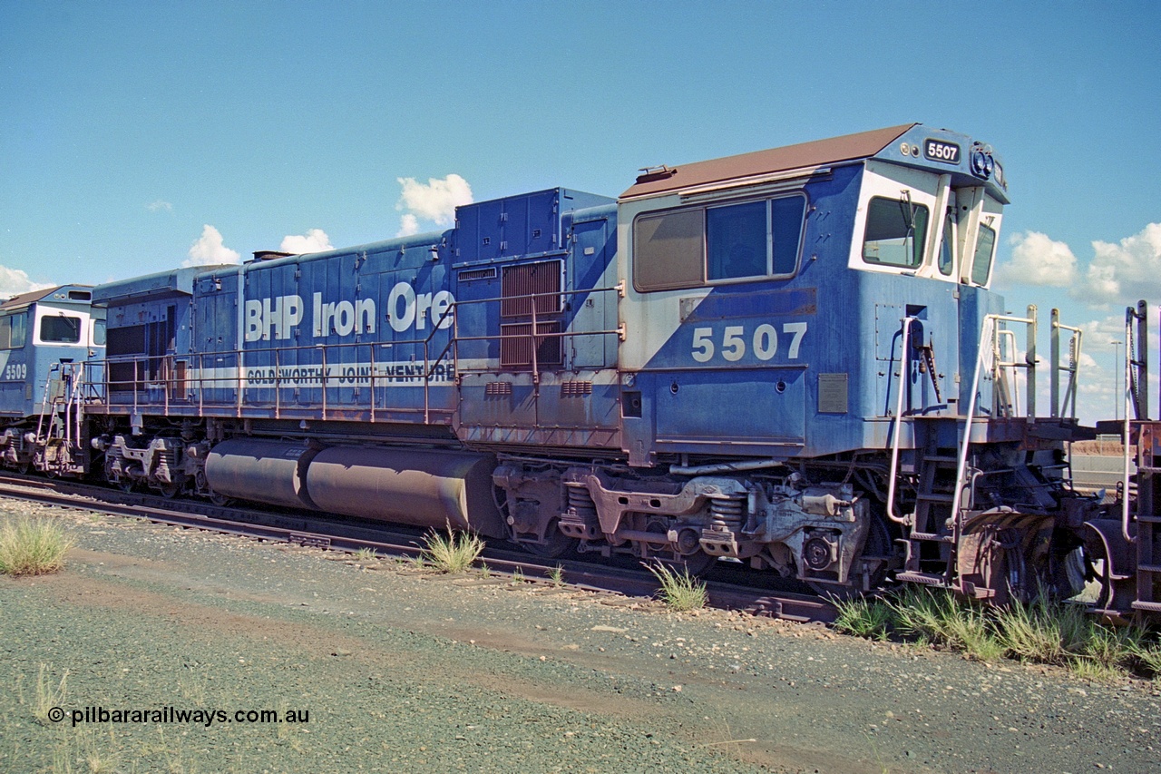 251-06
Nelson Point, BHP's recently retired Goninan WA ALCo C636 to GE C36-7M rebuild unit 5507 awaits its fate. Rebuilt in 1987 at Goninan's Welshpool factory from 1969 AE Goodwin built ALCo C636 with serial number G6035-2 and road number 5461 and assigned new serial number 4839-03 / 87-072. It was delivered in Mt Newman Mining orange and was named Ethel Creek, then in 1991 5507 emerged in BHP livery carrying Mt Whaleback, then renamed to Corunna Downs and again finally to Nimingarra, it was also one of three units to carry the Goldsworthy Joint Venture lettering. In 2003 it was fully rebuilt and leased to Pilbara Rail in that livery and numbered 5051. It survives stored at 7 mile complex as at Dec 2021. 22nd April 2000.
Keywords: 5507;Goninan;GE;C36-7M;4839-03/87-072;rebuild;AE-Goodwin;ALCo;C636;5461;G6035-2;