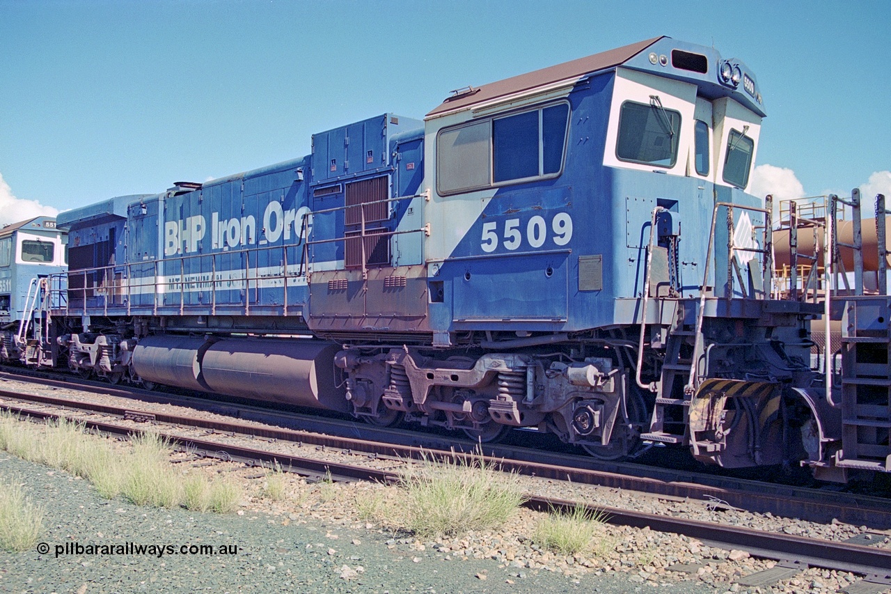 251-09
Nelson Point, BHP's recently retired Goninan WA ALCo C636 to GE C36-7M rebuild unit 5509 awaits its fate. Rebuilt in 1987 at Goninan's Welshpool factory from 1969 AE Goodwin built ALCo C636 with serial number G6012-1 and road number 5452 and assigned new serial number 4839-05 / 87-074. It was delivered in Mt Newman Mining orange and was named Chichester. 5509 was subsequently cut down in September 2003 and then sent to United Goninan's Lansdowne NSW facility for use as an engine test bed, then later to Broadmeadow NSW. 22nd April 2000.
Keywords: 5509;Goninan;GE;C36-7M;4839-05/87-074;rebuild;AE-Goodwin;ALCo;C636;5452;G6012-1;