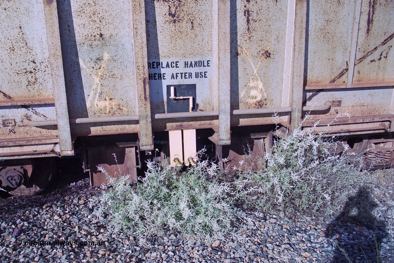 251-34
Bing Siding, BHP ballast waggon 509 sits in a dead end siding very much unloved. View of the ballast discharge chutes and the manual handle. Originally an ore waggon and built by Magor USA and was one of the original fleet of waggons to come out to WA with the car dumper at the beginning of the Mt Newman project. 22nd April 2000.
Keywords: Magor-USA;BHP-ballast-waggon;