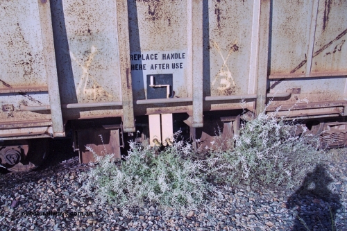 251-34
Bing Siding, BHP ballast waggon 509 sits in a dead end siding very much unloved. View of the ballast discharge chutes and the manual handle. Originally an ore waggon and built by Magor USA and was one of the original fleet of waggons to come out to WA with the car dumper at the beginning of the Mt Newman project. 22nd April 2000.
Keywords: Magor-USA;BHP-ballast-waggon;