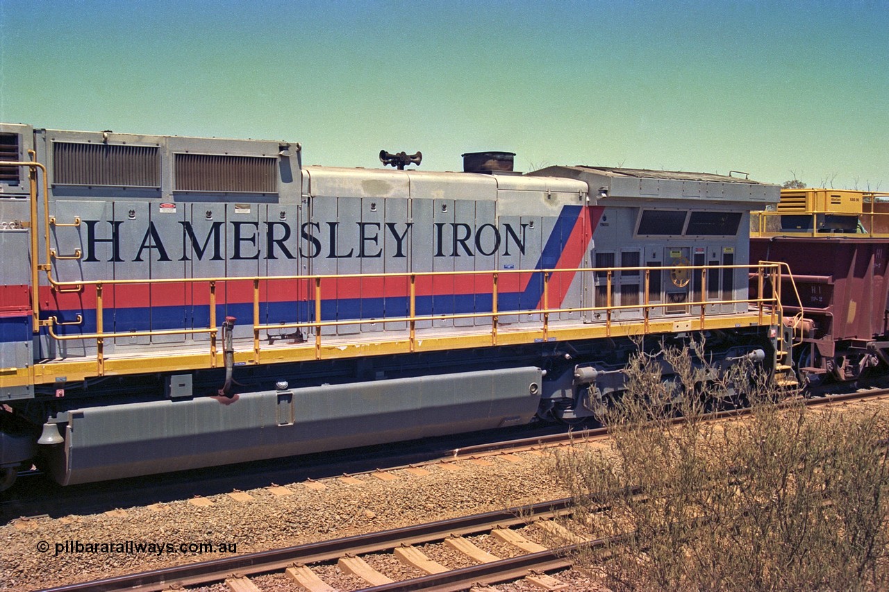 252-08
Cockatoo Siding 273 km on the Hamersley Iron line to Yandi, General Electric built 9-44CW unit 7088 with serial number 47767 from the original 1994 build idles away on the eastern end of the ballast train as it is loaded and slowly progresses into the back track siding Ballast plough BP 02 is behind the locomotive. View of the long hood, fuel tank and lettering. Location is roughly [url=https://goo.gl/maps/bCvLZxMc1z57F8ym9]here[/url]. 24th November 2001.
Keywords: 7088;GE;Dash-9-44CW;47767;