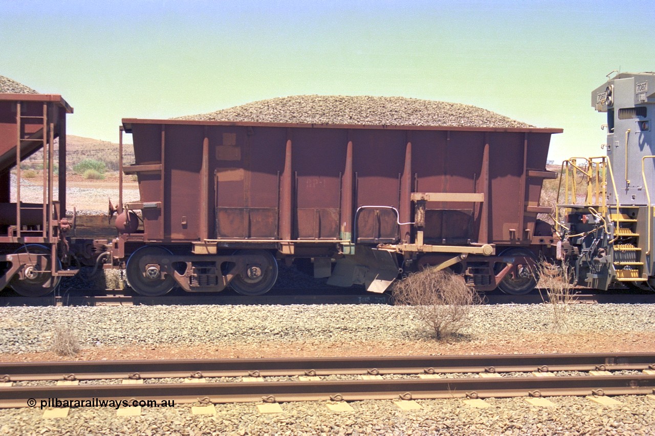 252-11
Cockatoo Siding 273 km on the Hamersley Iron line to Yandi, ballast plough waggon BP 02 is on the end of a ballast rake being loaded. BP 01 has been converted from an Nippon Sharyo ore waggon with the fitting of a plough blade, the waggon is also loaded with ballast for ballast. Location is roughly [url=https://goo.gl/maps/gNdgoAj6uJoYb2q36]here[/url]. 24th November 2001.
Keywords: BP-type;BP01;Rio-ballast-plough;Nippon-Sharyo;