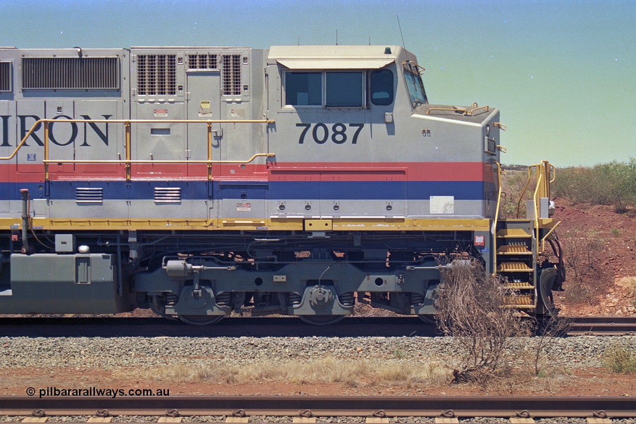 252-13
Cockatoo Siding 273 km on the Hamersley Iron line to Yandi, General Electric built 9-44CW unit 7087 with serial number 47766 from the original 1994 build idles away on the western end of the ballast train. Cab side view. Location is roughly [url=https://goo.gl/maps/rNdCHRcDhbQuHTjd7]here[/url]. 24th November 2001.
Keywords: 7087;GE;Dash-9-44CW;47766;