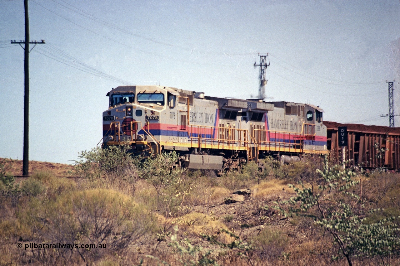 253-01
Dugite near the 64 km on the Dampier - Tom Price railway, a loaded Hamersley Iron train headed up by General Electric 9-44CW units 7078, from the original order, serial number 47757 and 7096, from the second order, serial number 52843 arrive taking the mainline to cross an empty which is in the passing track.
Keywords: 7078;GE;Dash-9-44CW;47757;