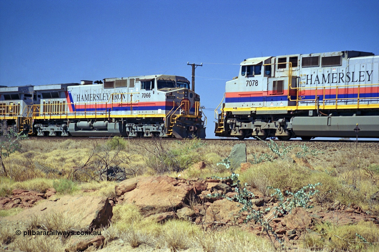 253-04
Dugite near the 64 km on the Dampier - Tom Price railway, as an empty Hamersley Iron ore train sits in the passing track behind General Electric 9-44CW unit 7066 with serial number 47745 as a loaded rolls by on the mainline behind sister 9-44CW unit 7078 serial number 47757. Both of these units are from the original order and built in October 1994.
Keywords: 7066;GE;Dash-9-44CW;47745;