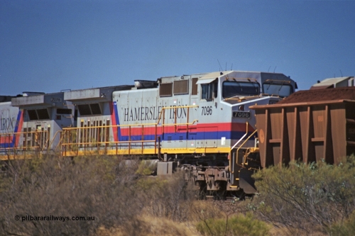 253-06
Dugite near the 64 km on the Dampier - Tom Price railway, second unit on a loaded Hamersley Iron train General Electric 9-44CW unit 7096 from the second order of locomotives with serial number 52843.
Keywords: 7096;GE;Dash-9-44CW;52843;